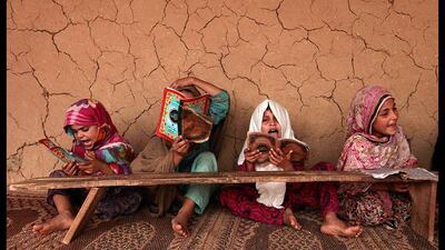Girls read books containing short verses from the Koran in a madrasa (religious school) on the outskirts of Islamabad, Pakistan. Faisal Mahmood / Reuters