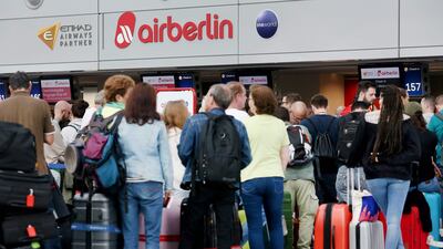 Flight passengers crowd in front of the desk of German airline Air Berlin at the airport in Duesseldorf, western Germany, on after lots of pilots called in sick, leading to cancellations. Roland Weihrauch/AFP