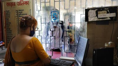 Passengers wait at a railway ticket counter after service reopened for the public after seven months of closure due to the coronavirus pandemic crisis, in Kolkata, India. EPA