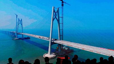 A screen showing the construction of the China-Zhuhai-Macau-Hong Kong Bridge. AP