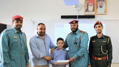 Civil Defence honour Abdallah Mohammed Abu Zahra who used his smarts to help a trapped brother and sister by taking a screwdriver and using it to prise open the door of the lift at his residential building. Courtesy Ajman Civil Defence