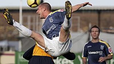Cardiff City's Gabor Gyepes contests for a header with Arsenal's Robyn van Persie in a goalless FA Cup fourth round tie at Ninian Park.