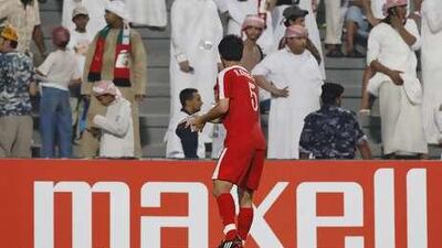 Ri Kwang Chon of North Korea, cleans up water bottles that were thrown on to the field by fans during the UAE vs North Korea 2010 FIFA World Cup Asian Qualifiers at Sheikh Mohammed Bin Zayed Stadium.
