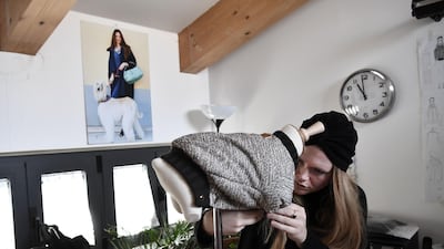 Aan employee working on an outfit for dog in the workshop. AFP