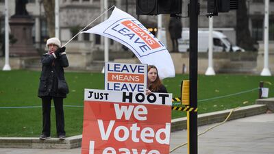 Pro Brexit supporters display signs outside the Houses of Parliament in Westminster in London, Britain. EPA