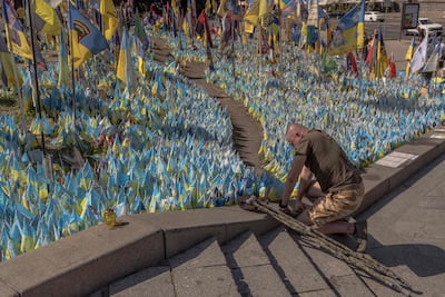 A Ukrainian military veteran commemorates fallen fighters, including members of his own family, at Independence Square in Kyiv in August. AFP
