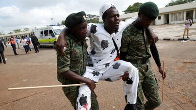 Policemen carry an injured man after police fired tear gas to try to control a crowd of people trying to force their way into a stadium to attend the inauguration of Kenya's president Uhuru Kenyatta at Kasarani Stadium in Nairobi, Kenya on November 28, 2017. Baz Ratner / Reuters