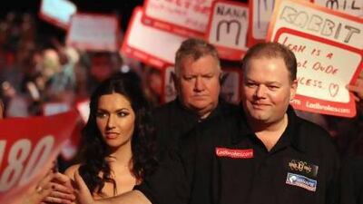 Raymond van Barneveld, right, of the Netherlands may not be a household name but at a darts event he enters the arena like a champion prize fighter coming to the ring.
