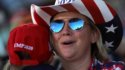 US President Donald Trump is seen reflected in the glasses of a supporter as he speaks during a campaign rally in Carson City. REUTERS