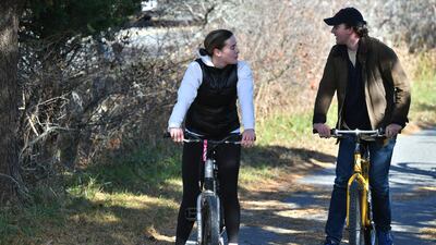 Naomi Biden, the granddaughter of US President Joe Biden, and her fiance Peter Neal ride bikes in Nantucket, Massachusetts. AFP
