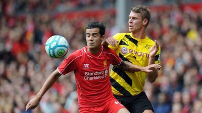 Philippe Coutinho, left, of Liverpool and Lukasz Piszczek of Borussia Dortmund battle for the ball during the Pre Season Friendly match between Liverpool and Borussia Dortmund at Anfield on August 10, 2014 in Liverpool, England. Clint Hughes/Getty Images
