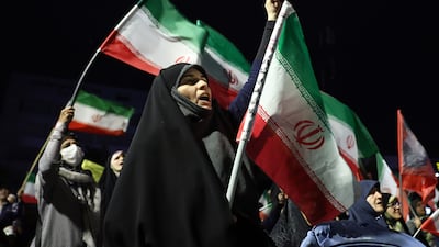 Iranians hold national flags during a gathering in support of the Iranian government and against the US and Israel in Tehran, Iran. EPA