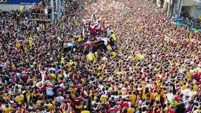 Devotees follow the carriage transporting the statue of the Black Nazarene. AFP