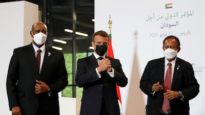 French President Emmanuel Macron, Sudan's Sovereign Council Chief General Abdel Fattah al-Burhan (L) and Sudan's Prime Minister Abdalla Hamdok react after a joint press conference during the International Conference in support of Sudan at the temporary Grand Palais in Paris. AFP