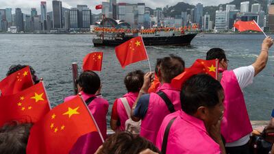 Pro-Beijing supporters in Hong Kong hold Chinese flags to mark the 27th anniversary of its return to Chinese rule. AP Photo