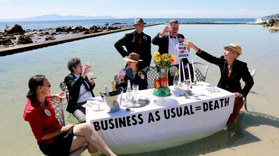 Members of Extinction Rebellion stage a protest at the Glencairn tidal pool outside Cape Town, South Africa to mark Cop27's 'Water Day'. AP