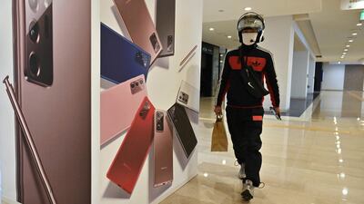 A man walks past a Samsung advertisement at the company's Seocho building in Seoul. The South Korean electronics giant sold 80.2 million smartphones worldwide in the third quarter, almost 1.3 million more than the same period last year. AFP