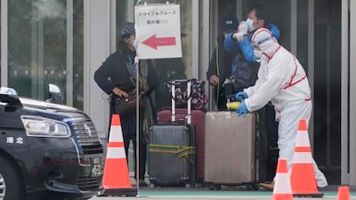 A passenger (L) of the Diamond Princess cruise ship prepares to leave the Daikoku Pier Cruise Terminal in Yokohama. EPA