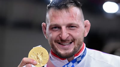 Czech Republic's Lukas Krpalek poses with his gold medal during the podium ceremony.
