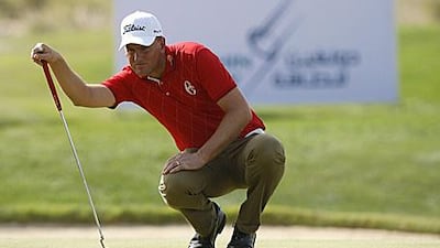 Robert Karlsson, the giant Swede, lines up a putt during his title-clinching round at the Doha Golf Club in Qatar yesterday.