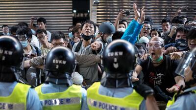 People jeer and yell at police officers as fresh clashes broke out on the weekend. Alex Gogle/AFP Photo