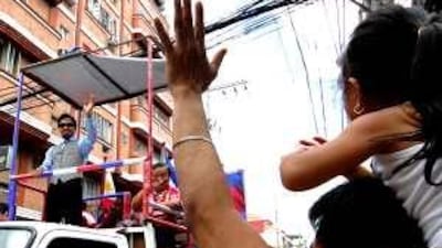 Filipino boxing superstar Manny Pacquiao, left, waves to his fans during a victory motorcade in Manila on March 22.