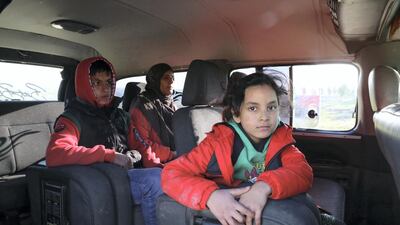 Haleema with her son Mohammed, 15, and daughter Basema, 11, leave for the Syria-Turkey border from Harem in Syria's Idlib province. Photo by Abdul Azez Ketaz