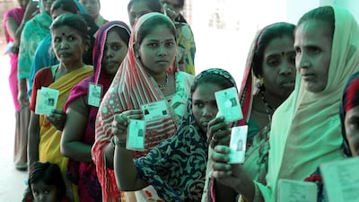Indian voters show their voter ID cards as they wait in a queue to cast their votes at a polling station during the sixth phase of the Indian parliamentary election in Bhopal, India. EPA