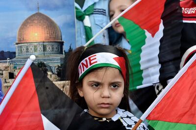 A Palestinian girl with a national flag on her head attends a protest against the so-called 'deal of the century' in Beirut. EPA