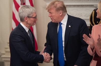 US President Donald Trump shakes hands with Apple's Tim Cook during the first meeting of the American Workforce Policy Advisory Board in the State Dining Room of the White House in 2019. AFP