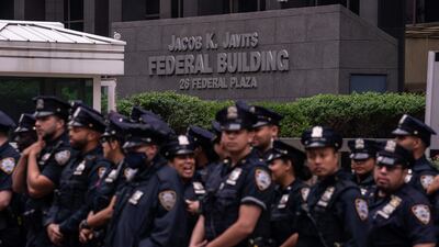 Police stand guard before a protest against federal immigration raids outside a federal building in New York City. AFP