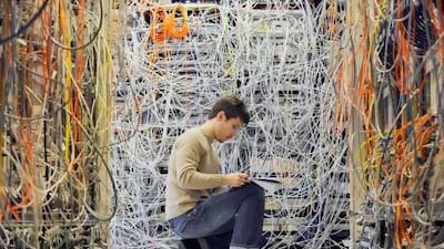 An engineer checks communication cables in the Media Gateway lab in Ericsson's research and development center in Budapest, Hungary.