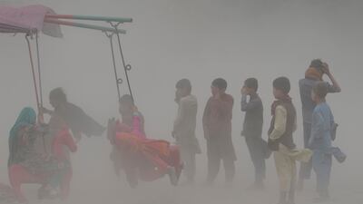 Children play during a sand storm in Kabul, Afghanistan. AP