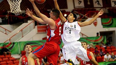 Vojislav Stojanovic, left, of Serbia drives to the basket against Ahmed Metwaly of Egypt during their Fiba Under 17 World Championship game at Al Ahli club in Dubai on August 9, 2014. Satish Kumar / The National