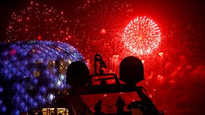 People are silhouetted on the flybridge of a yacht as fireworks illuminates the sky over the Yas Viceroy luxury hotel on the first day of the Muslim holiday of Eid Al Fitr at the Marina on Yas Island, Abu Dhabi. Ali Haider / EPA