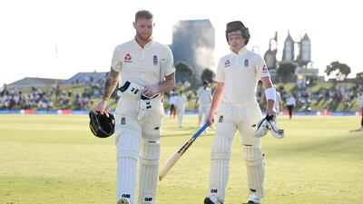 Ben Stokes, left, and Ollie Pope of England leave the field at stumps on day one. Getty