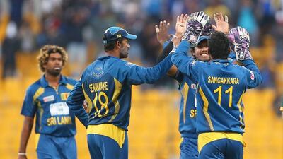 Sri Lankan players celebrate the dismissal of Pakistani batsman Misbah ul Haq during the fifth one-day international match yesterday in Abu Dhabi. Marwan Naamani / AFP