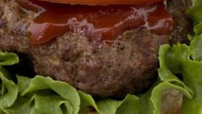 A hamburger drips with ketchup.