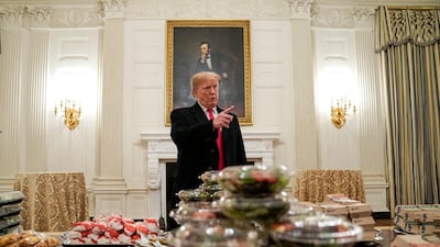 U.S. President Donald Trump speaks in front of fast food provided for the 2018 College Football Playoff National Champion Clemson Tigers due to the partial government shutdown in the State Dining Room of the White House in Washington, U.S., January 14, 2019. REUTERS/Joshua Roberts TPX IMAGES OF THE DAY