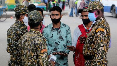 A patrol by members of the Bruhat Bengaluru Mahanagara Palike checks for people not wearing face masks in the south Indian city, where two cases of Omicron infection have been detected. EPA