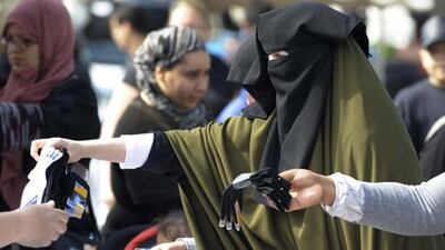 A retired French teacher who bit, slapped and scratched an Emirati tourist and removed her veil is given a one-month suspended sentence.
