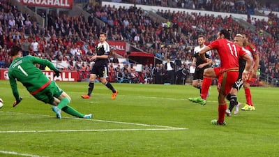 Wales' Gareth Bale scores past Belgium goalkeeper Thibaut Courtois to make it 1-0 on Friday night in their Euro 2016 qualifying contest. Geoff Caddick / EPA