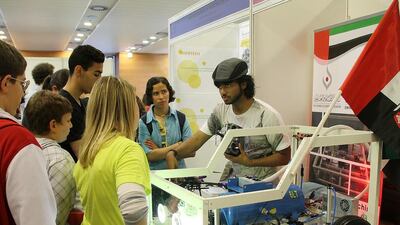 Tariq Gharib Juma, right, has won third place at a Barcelona competition for his invention that takes the hassle out of changing flat car tyres. He was competing against 200 others. Photo Higher Colleges of Technology