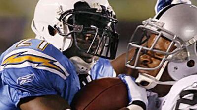 LaDainian Tomlinson, left, gets physical with the Oakland Raiders' Nnamdi Asomugha during the San Diego Chargers much needed win to keep their play-off hopes alive.