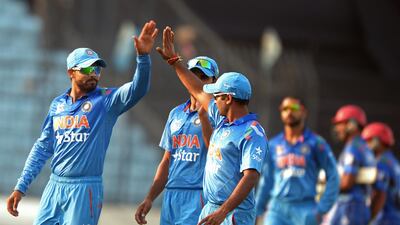 Ravindra Jadeja, left, took four Afghanistan wickets at the Sher-e-Bangla in Dhaka on Wednesday. Dibyangshu Sarkar / AFP