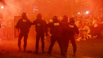 Riot police protect themselves from fans on the Champs Elysees. Reuters
