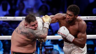 Defending champion Andy Ruiz Jr., left, takes a right cross to the face during his fight against Britain's Anthony Joshua in their World Heavyweight Championship contest at the Diriyah Arena, Riyadh, Saudi Arabia AP