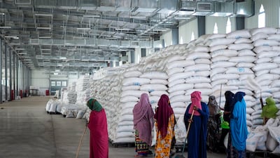 Workers clean the floor as sacks of food earmarked for the Tigray and Afar regions sit in piles in a warehouse of the World Food Programme in Semera, the regional capital for the Afar region in Ethiopia. AP