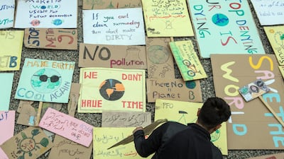 Activists drew posters with climate change messages to be used during protests in the city. Stefanie Glinski for The National