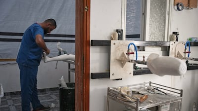 Prosthetic limb technician Ahmed Al Ashqar prepares a leg amputation splint in the first stage of building an artificial leg at Hamad Hospital in Gaza. AP